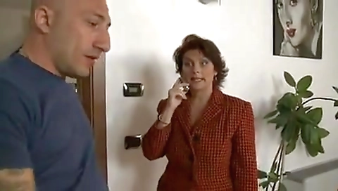 Mature woman pays the repairman.