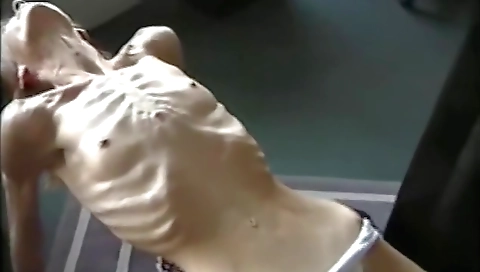 Muscular anorexic Nicole shows her body and squeezes her belly